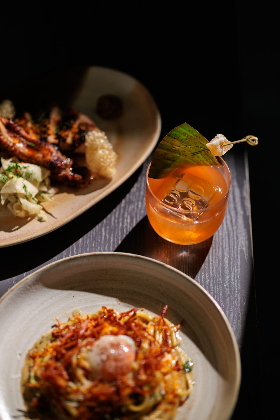 Grilled chicken, amber cocktail, and pasta